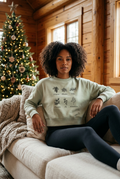 Female model wearing the Matcha sweatshirt on a cozy cabin couch